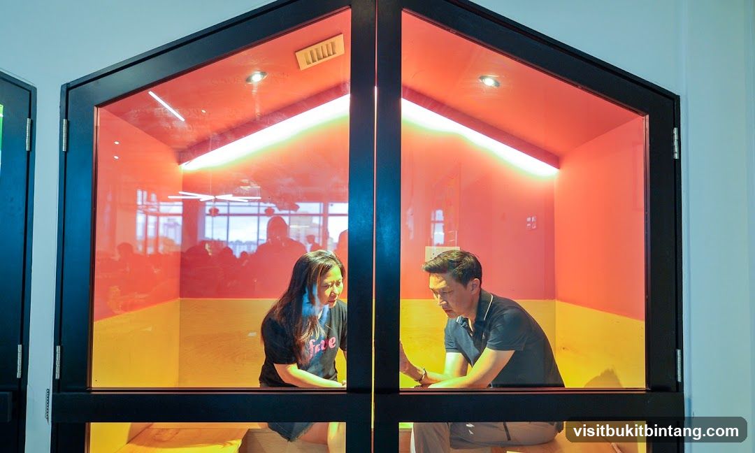 People in a brightly lit booth