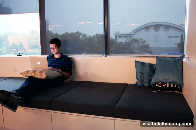 Man working on laptop by the window
