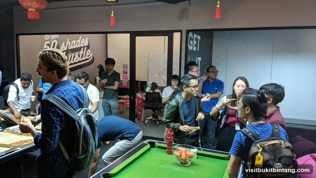 People eating pizza at a gathering