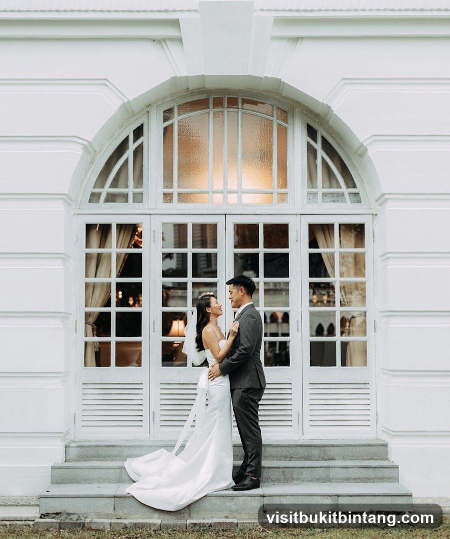 Wedding Couple Posing in Front of White Arched Doors