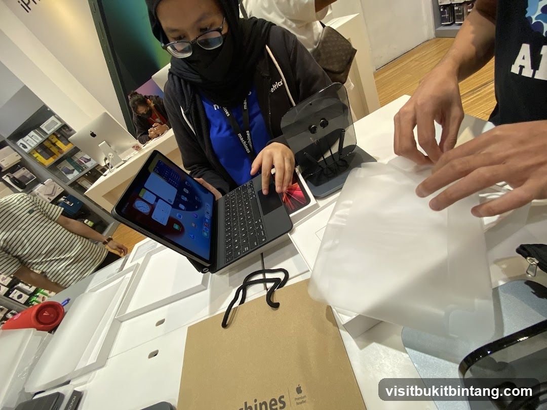 Customers interacting with electronics in a store