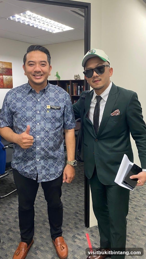Two men posing for a photo in an office