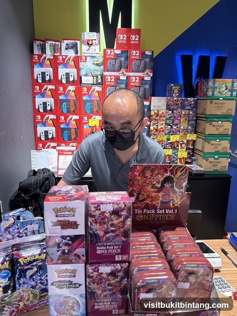 Man behind a counter with video games and trading cards