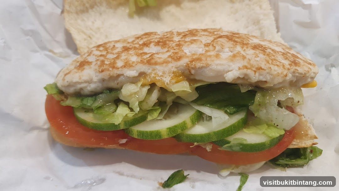Sandwich with Chicken, Lettuce, Tomato, and Cucumber