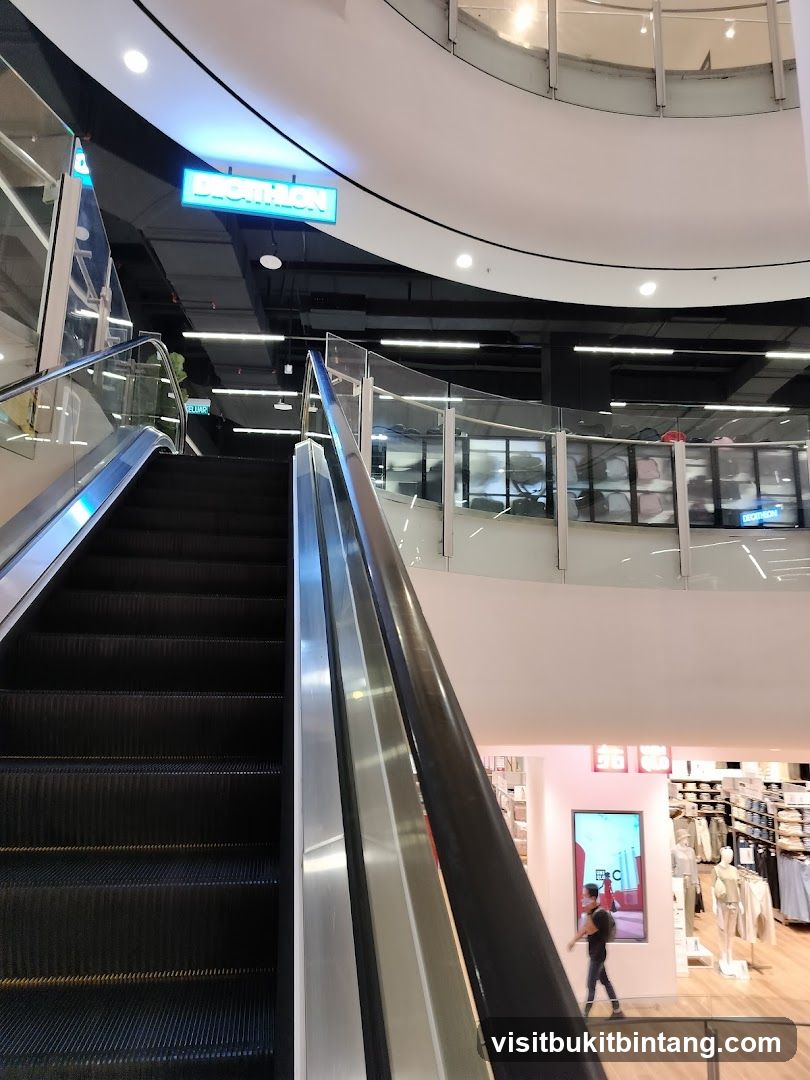 Escalator in a mall with store signage