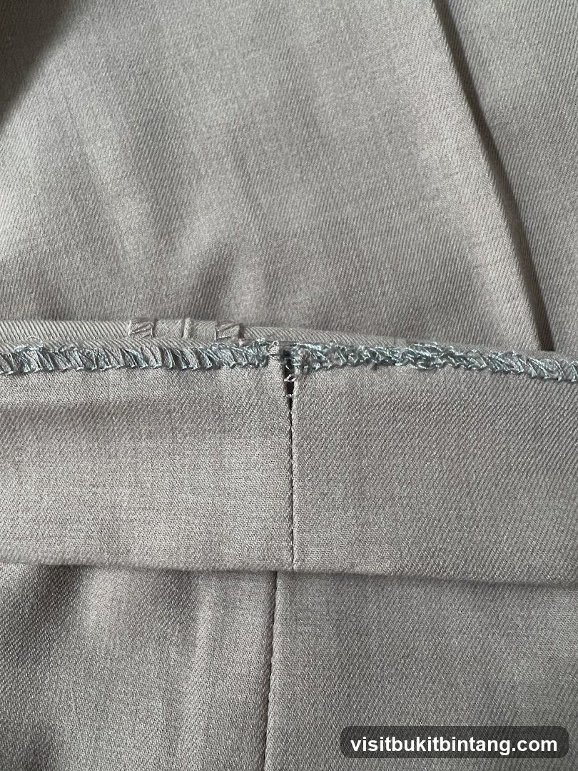 Close-up of a seam on light brown fabric