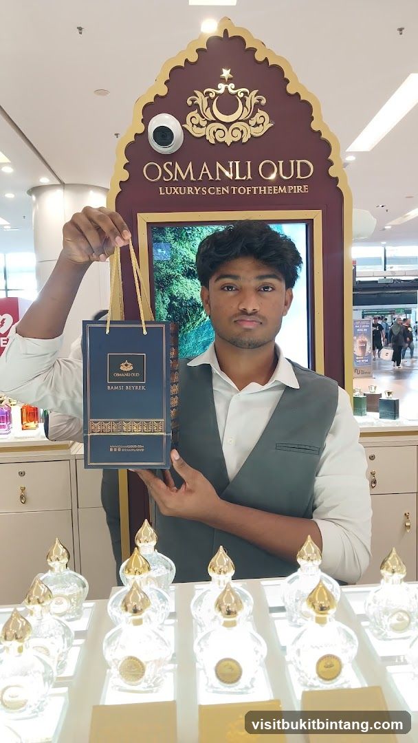Man holding a shopping bag at a perfume counter