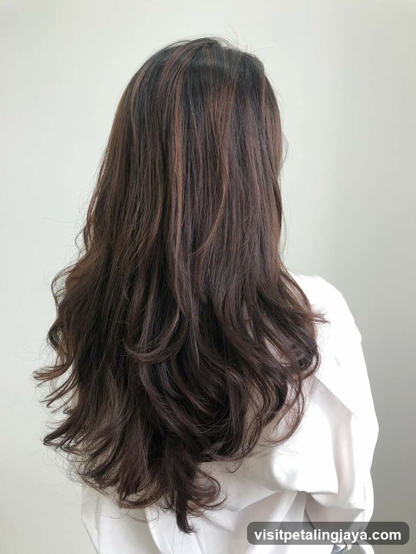 Back view of a person with long wavy hair