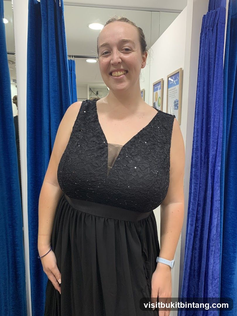 Woman in a black dress in a fitting room