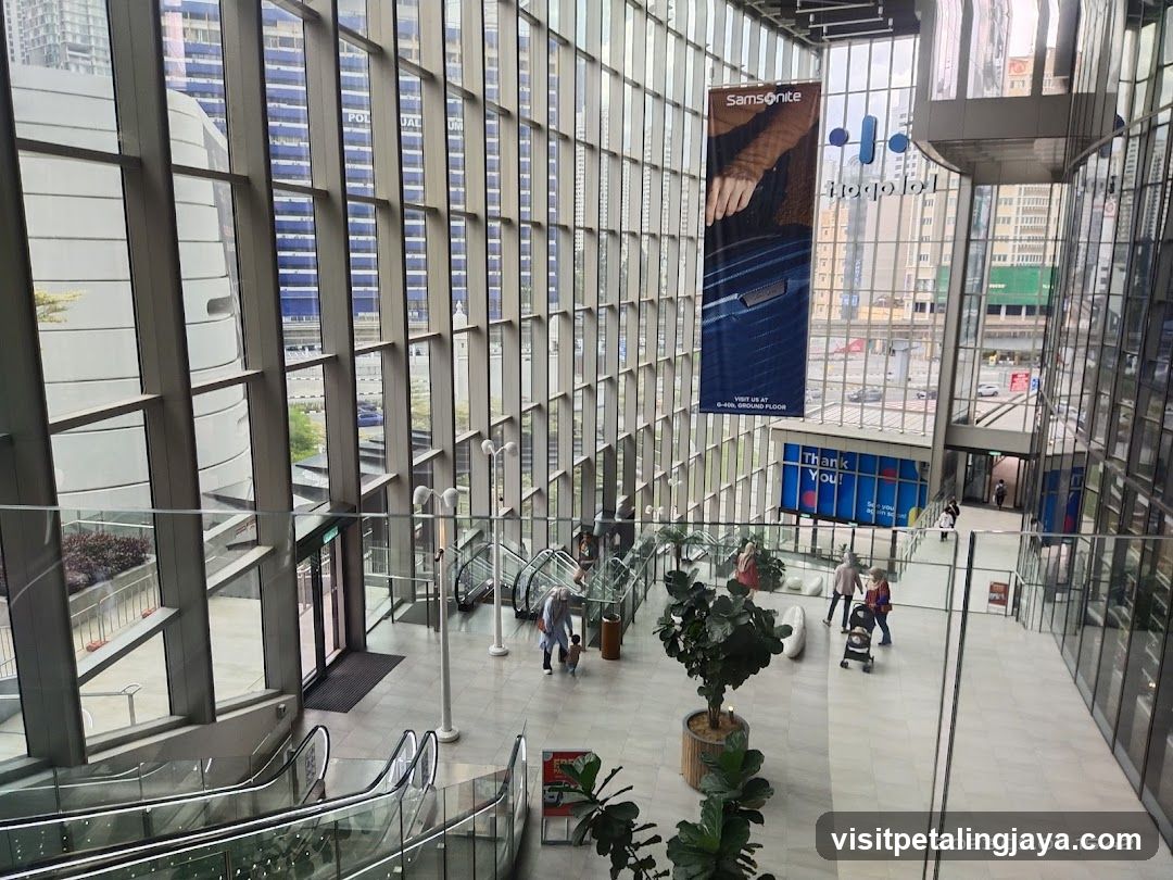 Modern atrium interior with glass facade and outdoor view