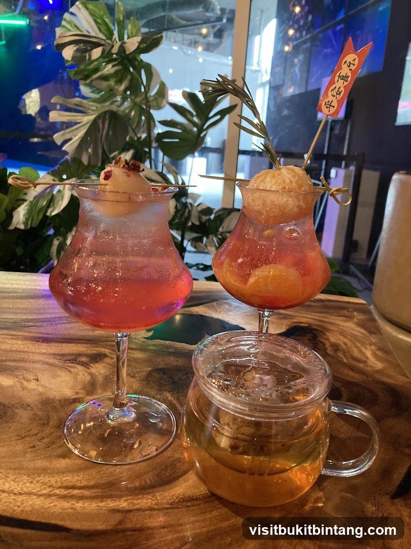 Two colorful cocktails and a tea in a glass mug