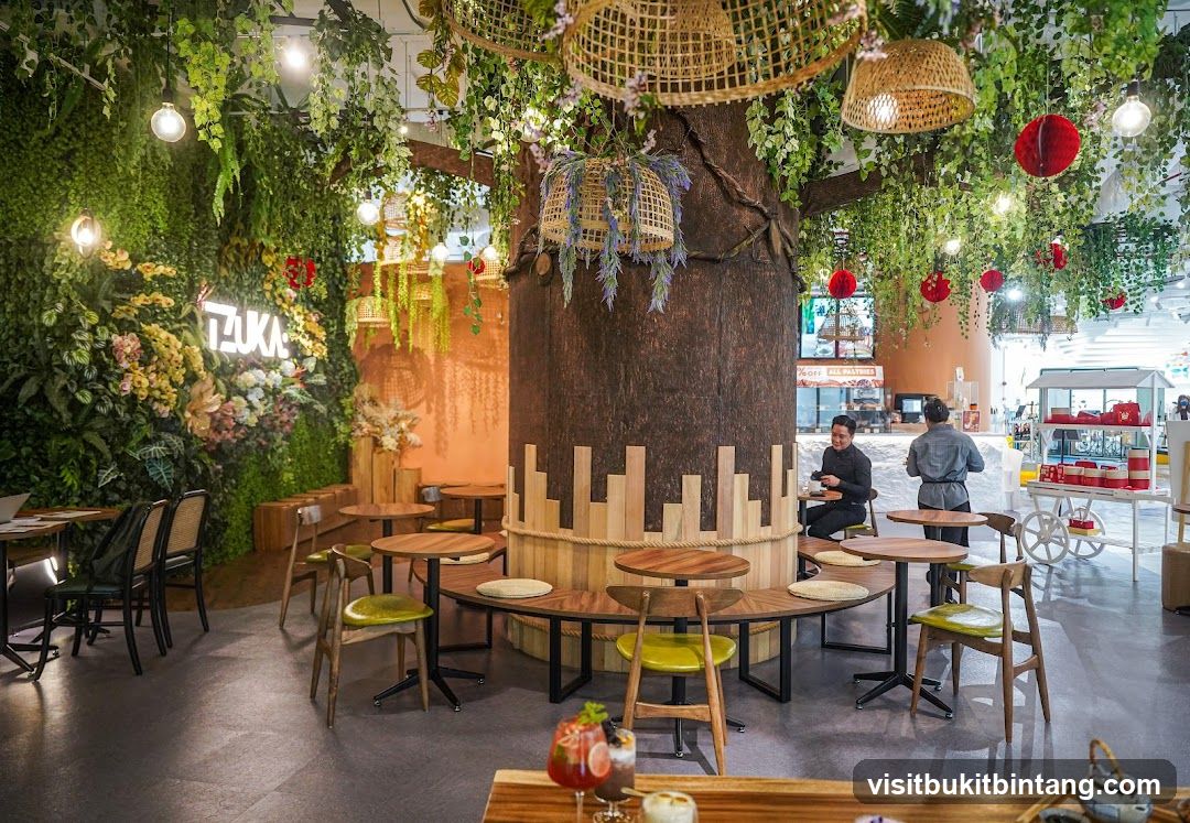 Cafe interior with a large tree and greenery