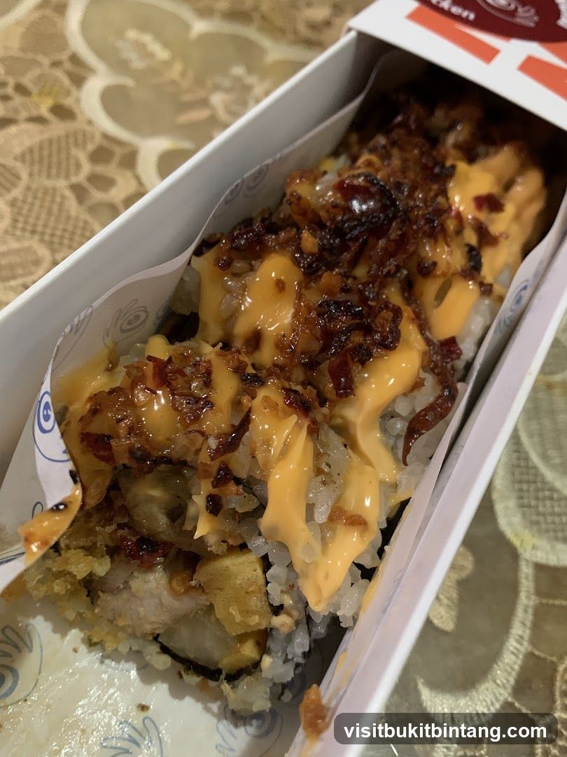 Sushi roll with sauce and toppings