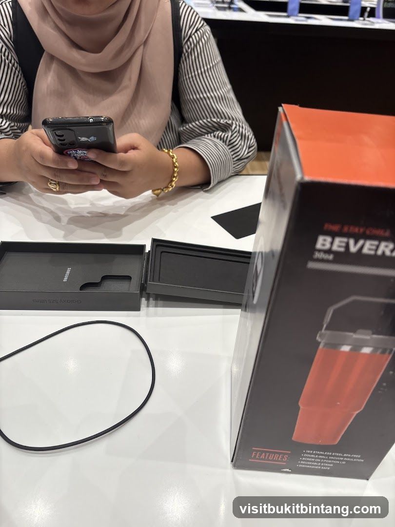 Person using a smartphone with a beverage container box