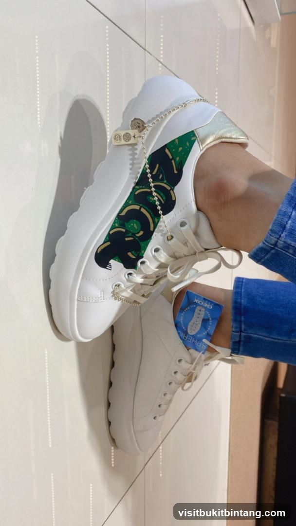 White sneakers with snake design
