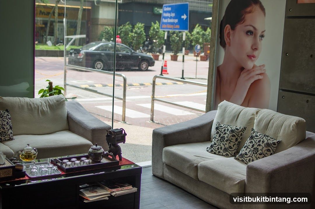 Waiting area with a large poster of a woman
