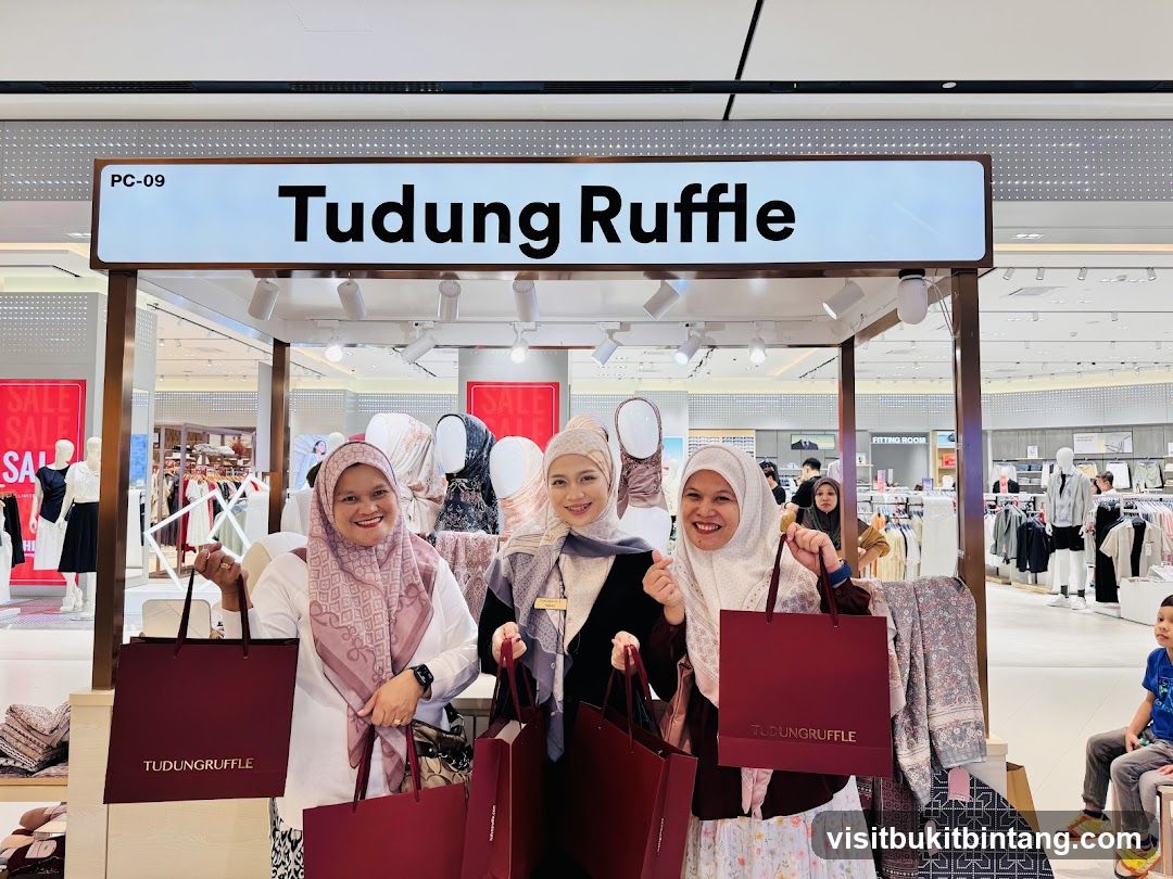 Women Posing with Shopping Bags at Tudung Ruffle