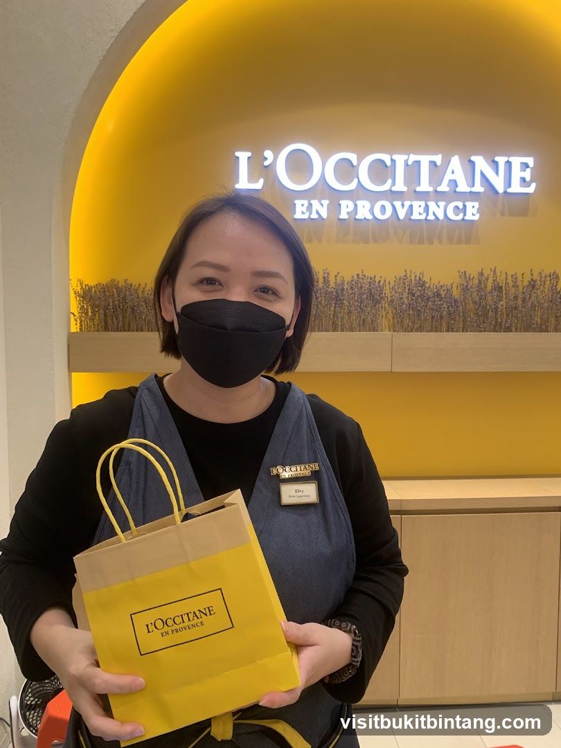 L'Occitane employee with shopping bag