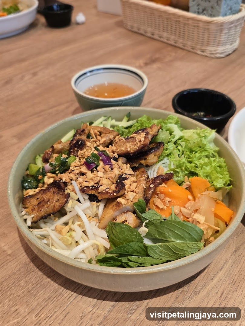 Bowl of Vietnamese-style noodle dish with toppings