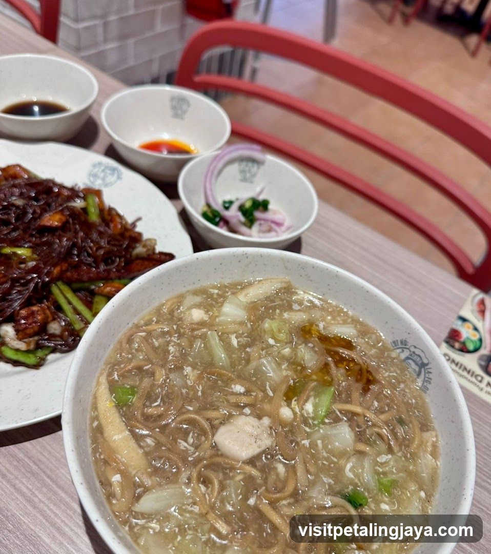 Dining Table with Noodles and Side Dishes