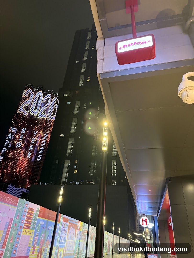 Nighttime street scene with illuminated buildings and signage