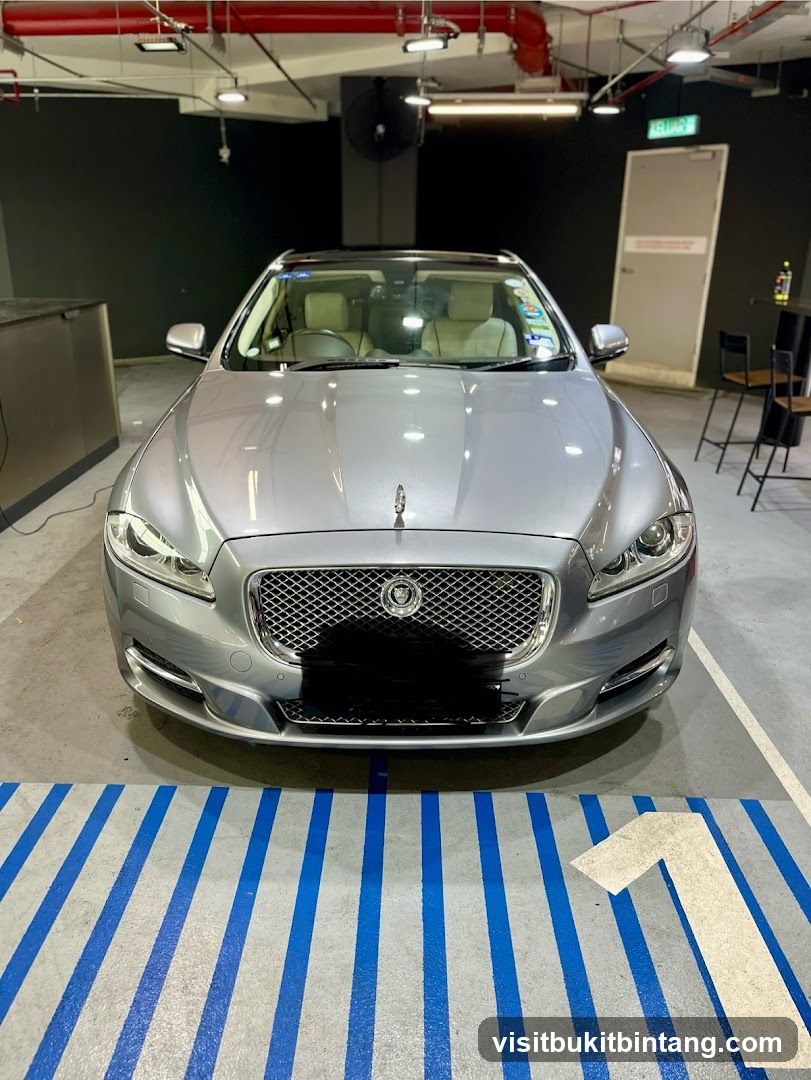 Silver Jaguar parked in a garage