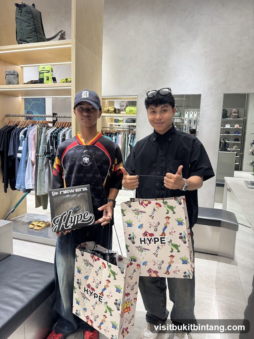 Two people holding shopping bags and a box in a store