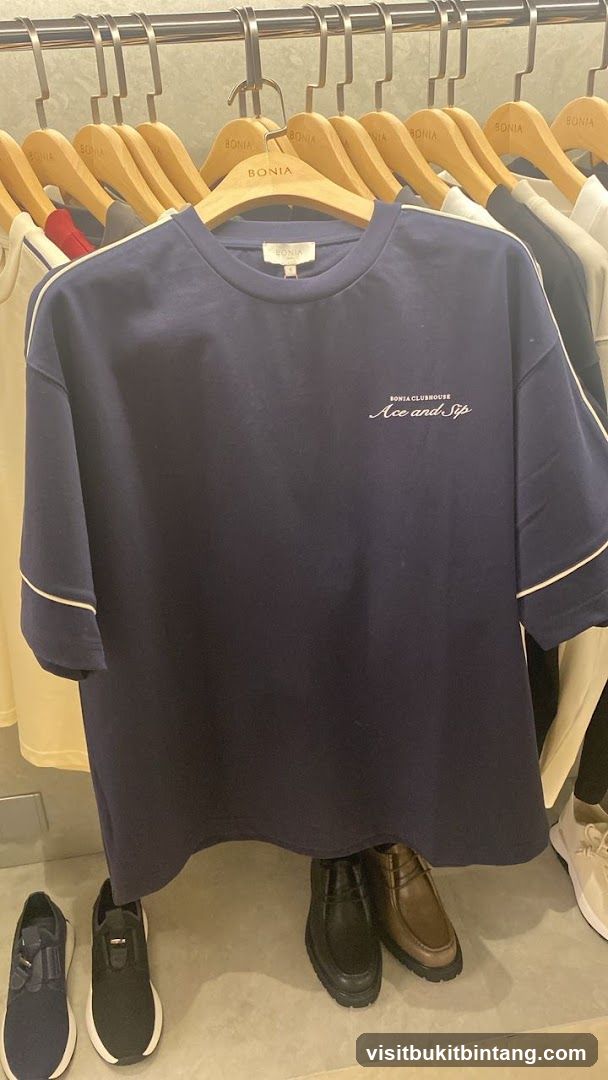 Navy T-shirt with white trim and embroidered text