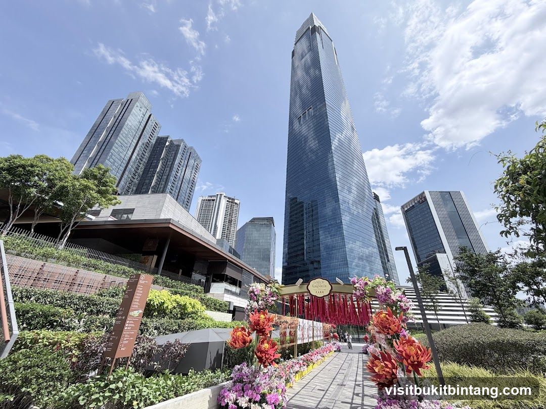 Outdoor walkway with floral decorations and skyscrapers