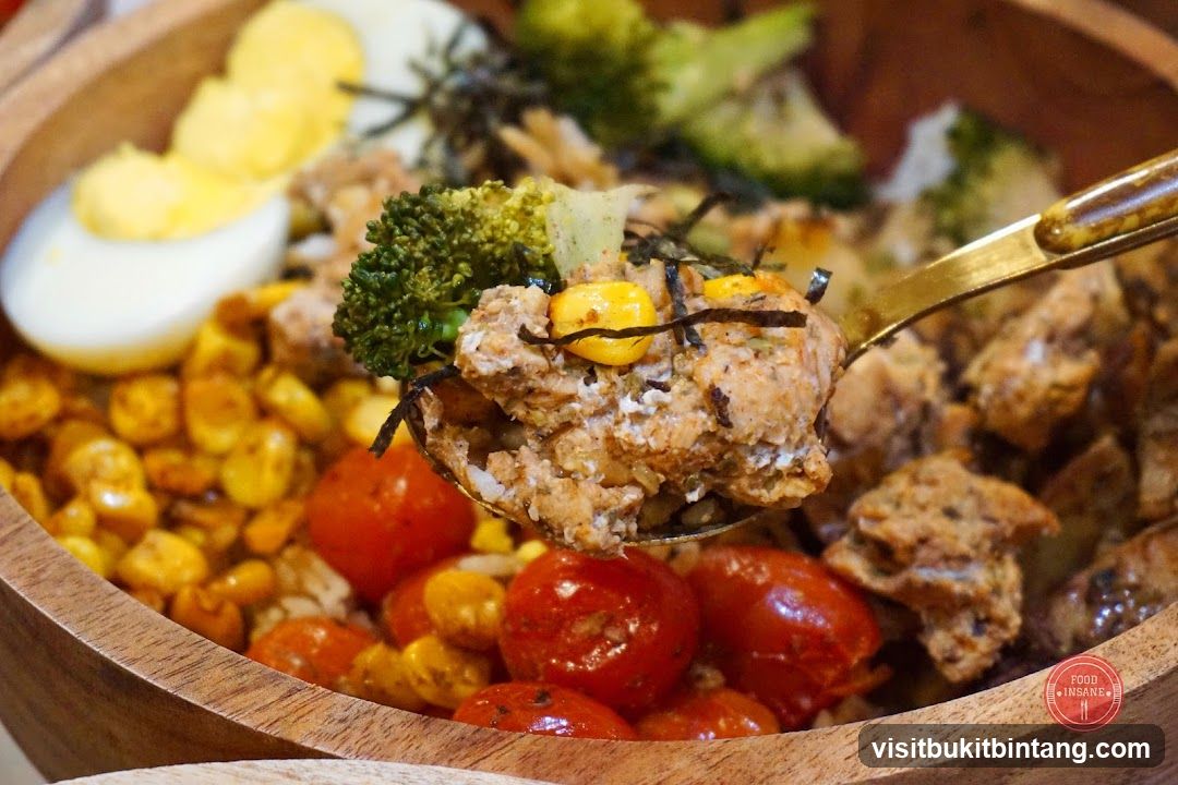 Close-up of a healthy grain bowl with chicken and vegetables.