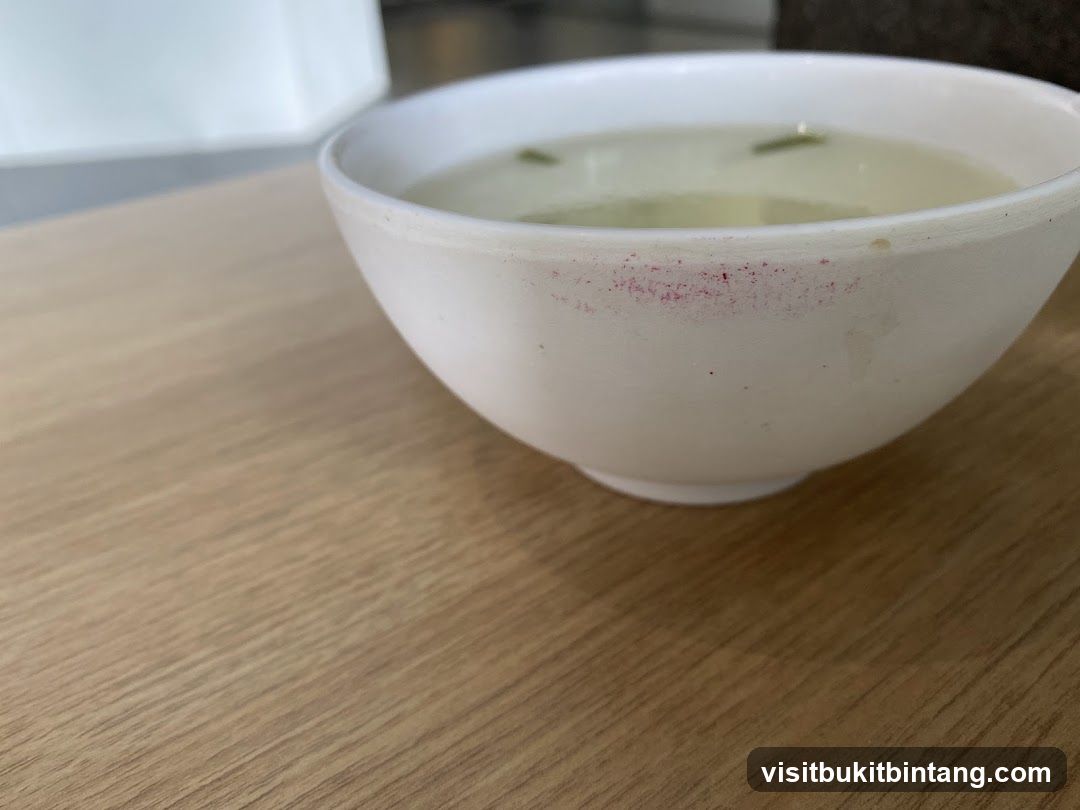 Bowl of soup with lipstick stain