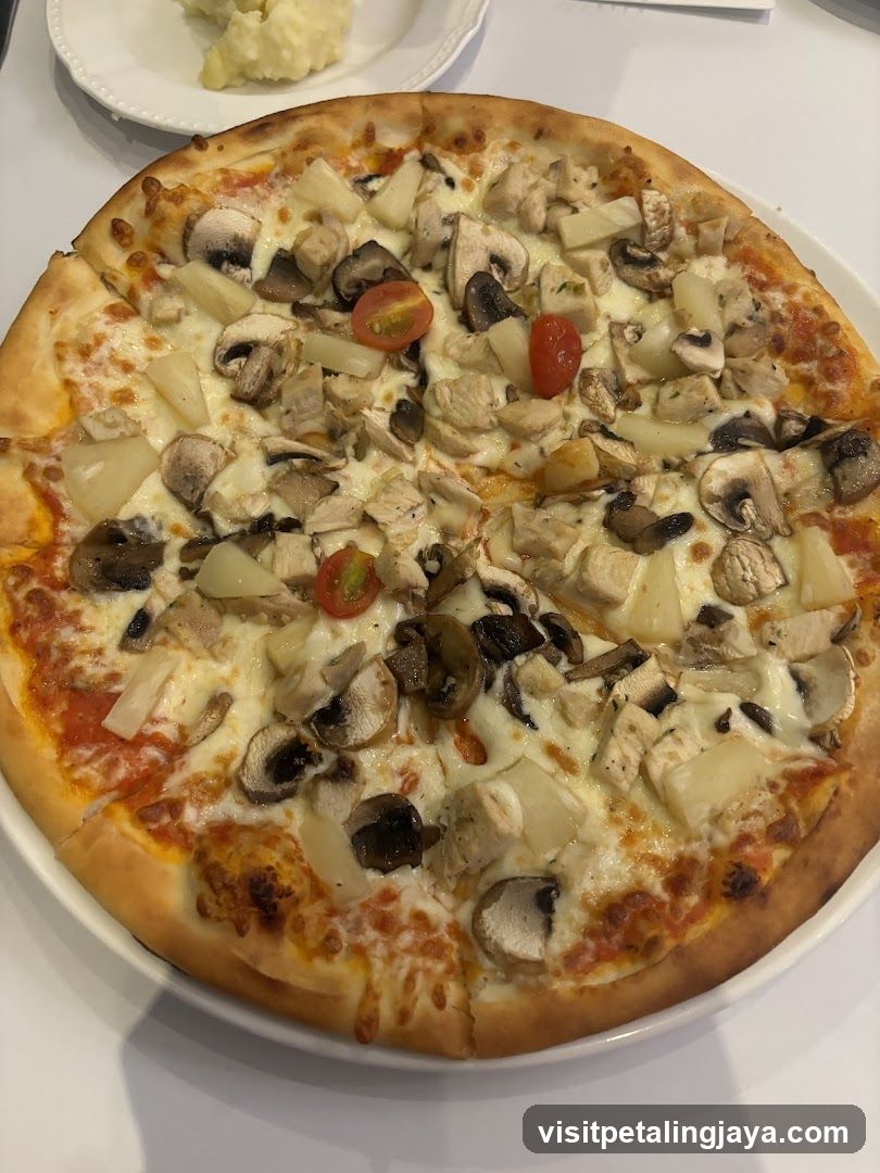 Pizza with mushrooms, pineapple and chicken