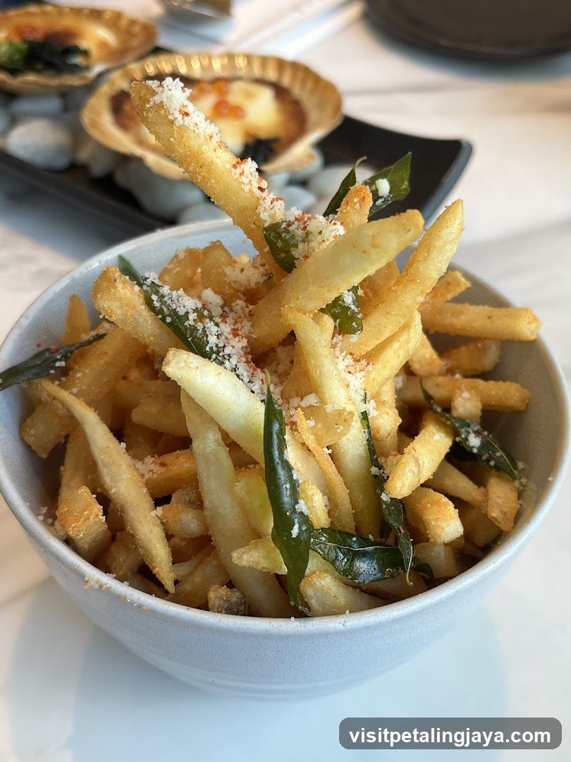 Fries with garnish and scallops in background
