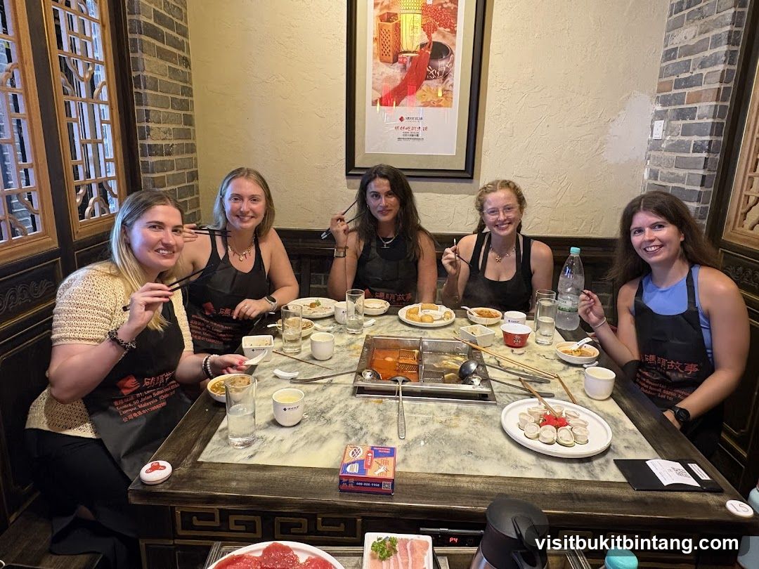 Friends enjoying a meal at a hot pot restaurant