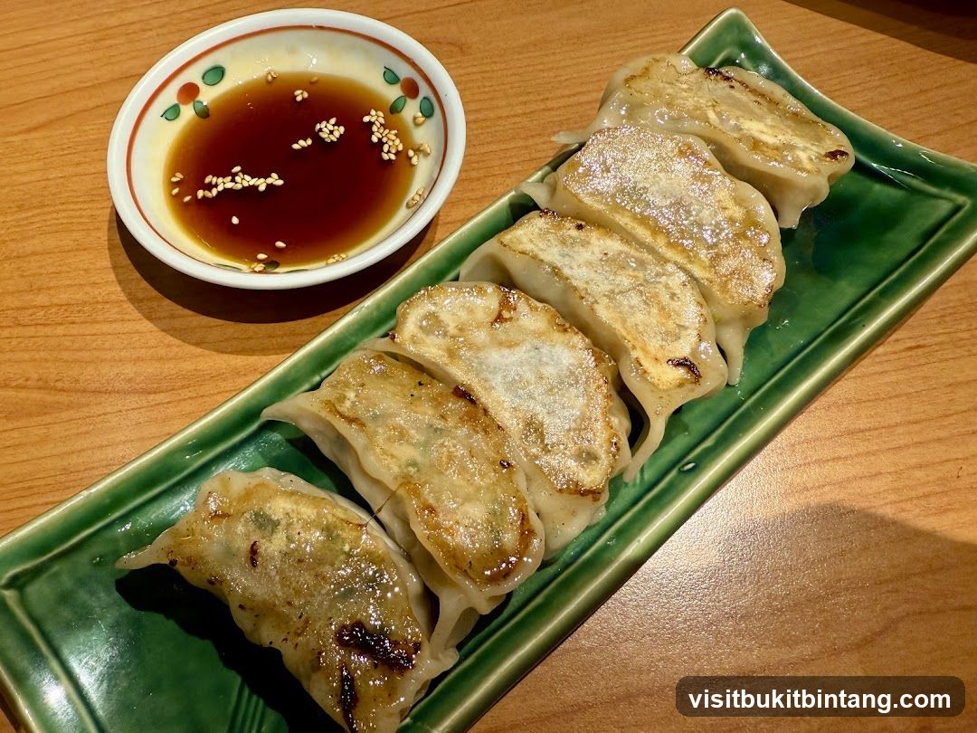Pan-fried dumplings with dipping sauce