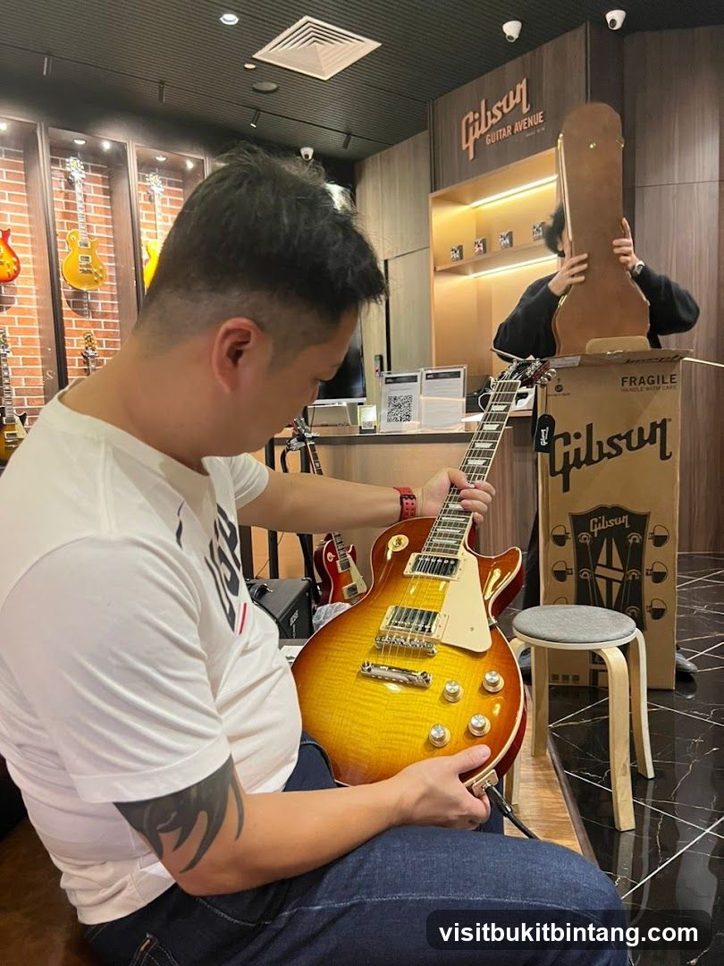 Man examining a Gibson guitar in a store