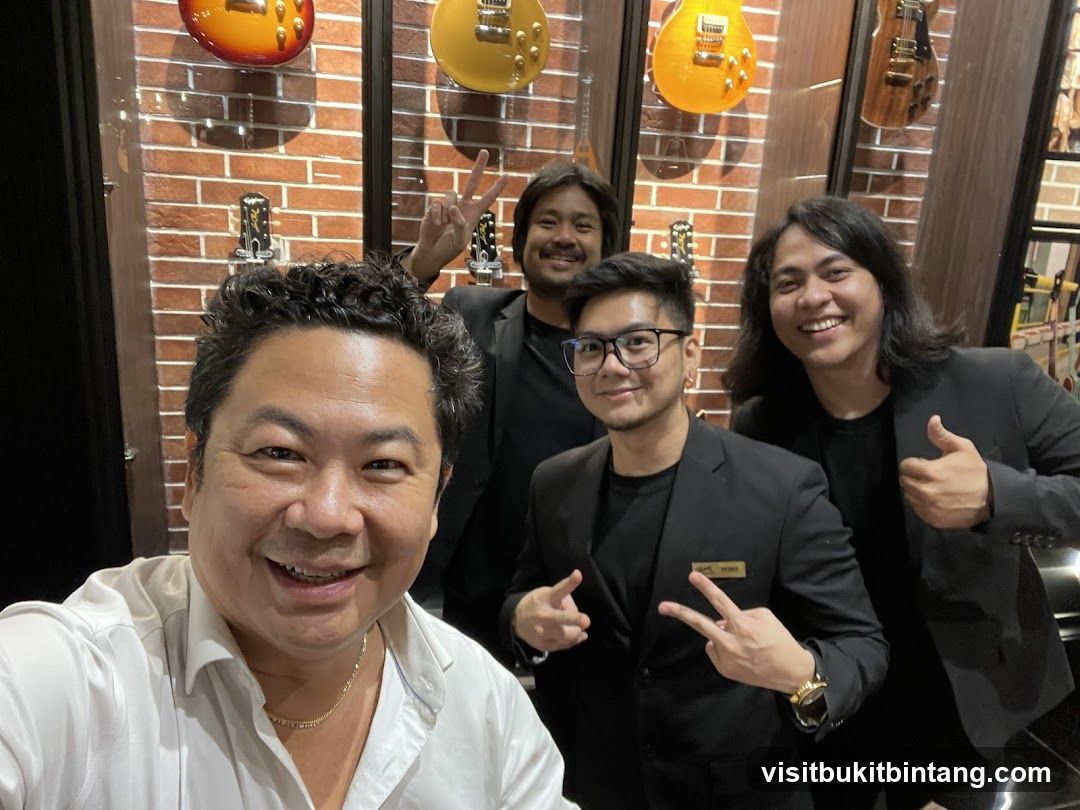 Four men posing for a photo in a guitar shop