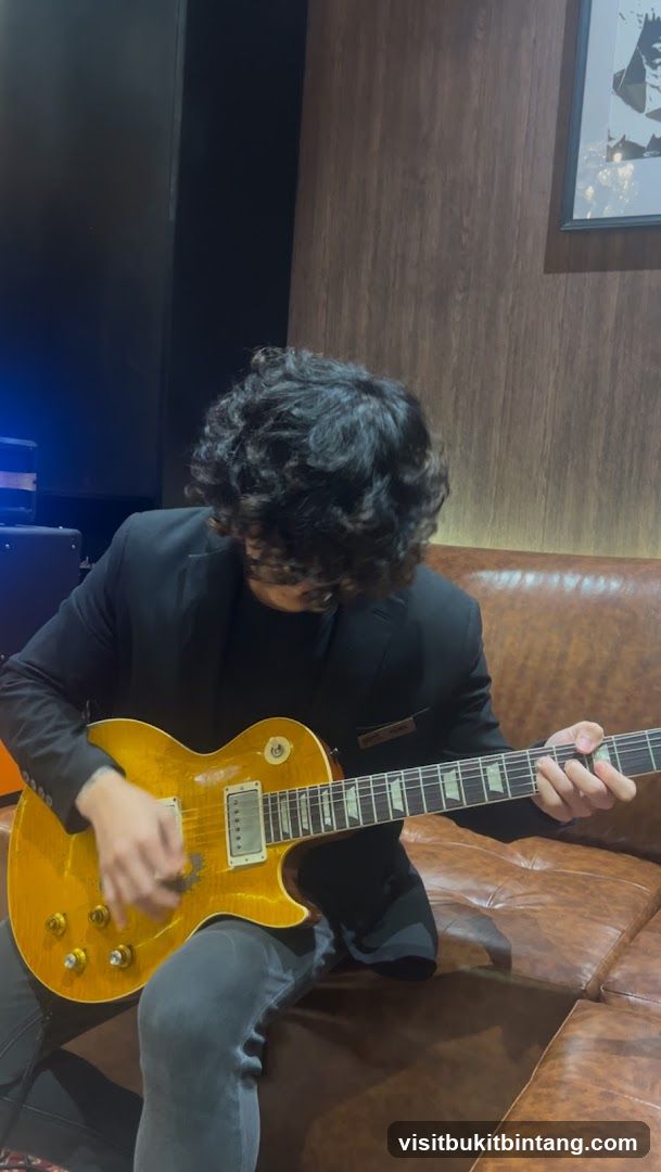 Man playing guitar on couch