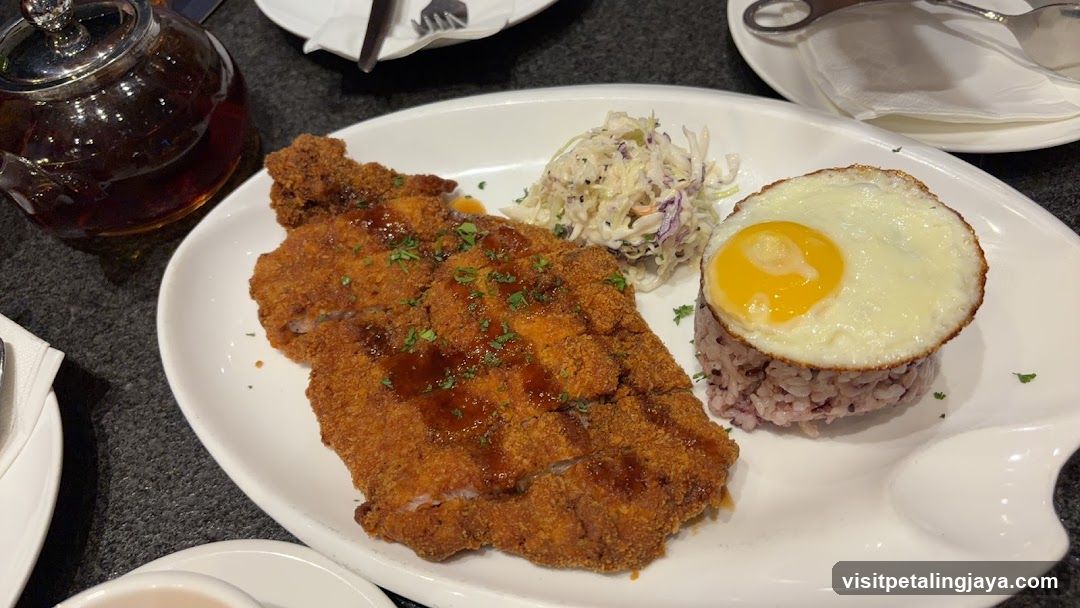 Breaded Cutlet with Fried Egg and Coleslaw