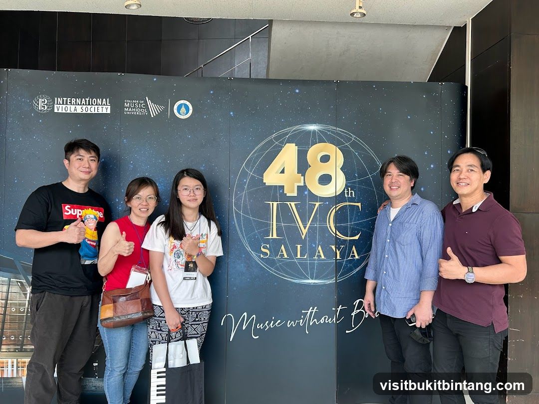 Group Poses in Front of Event Banner