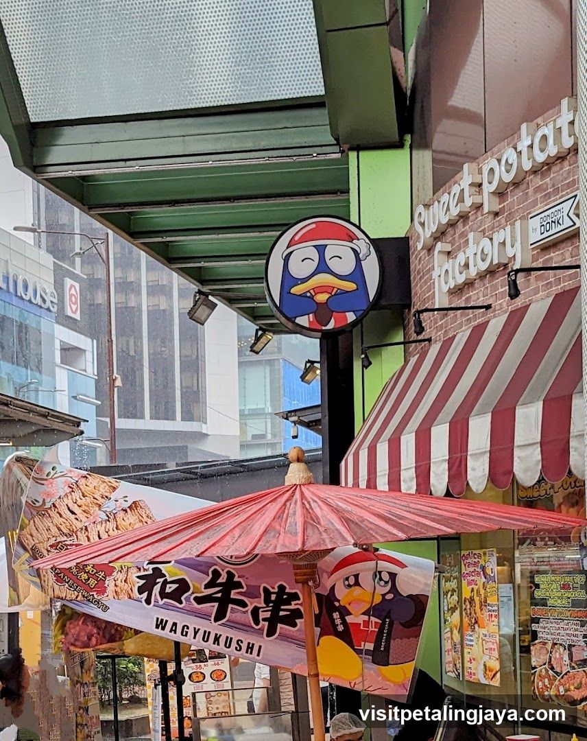 Street Food Scene with Red Umbrella and Shop Signage