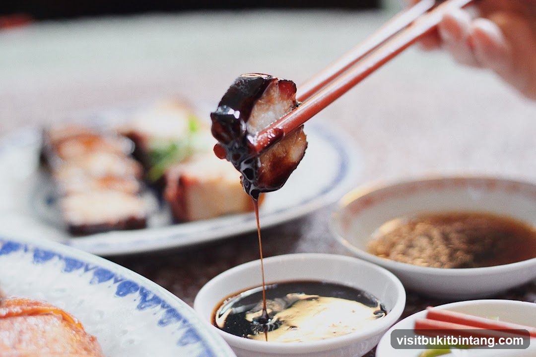 Dipping Roasted Pork Belly in Sauce