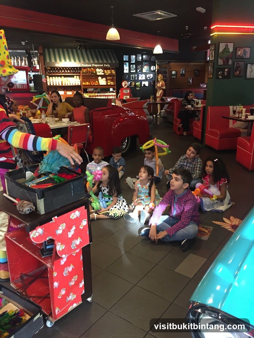 Clown entertaining children at a diner