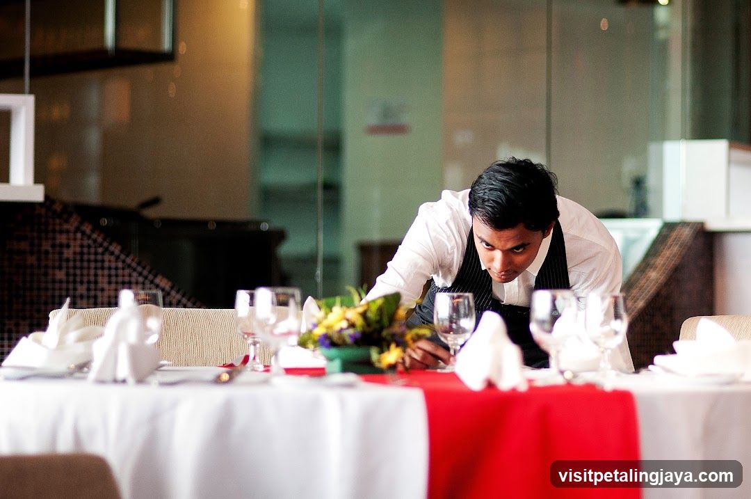 Waiter Setting a Table