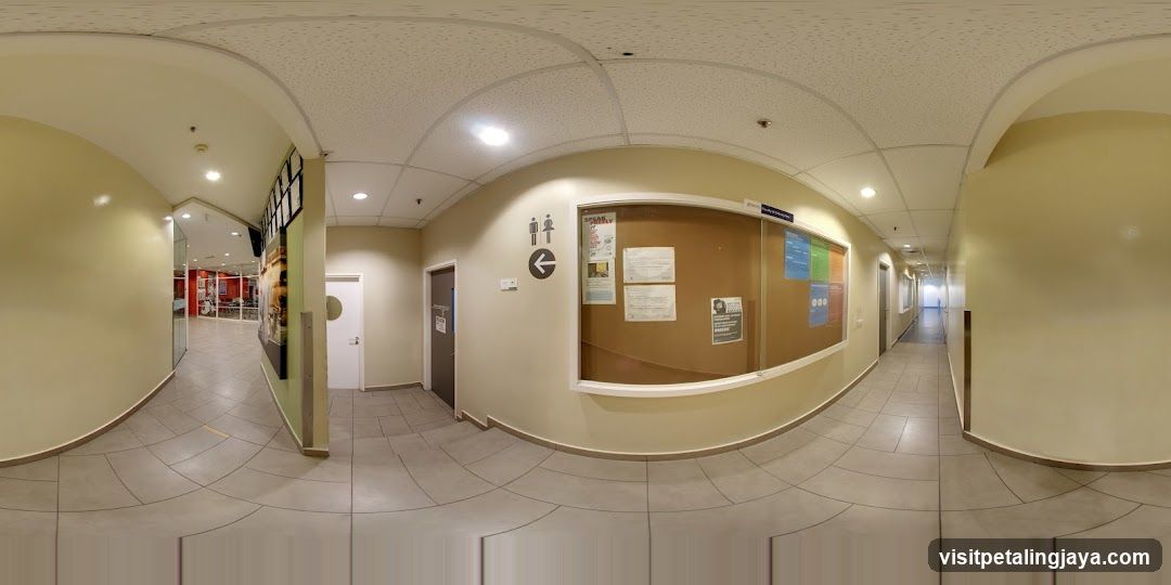 Hallway with Bulletin Board and Restroom Signs