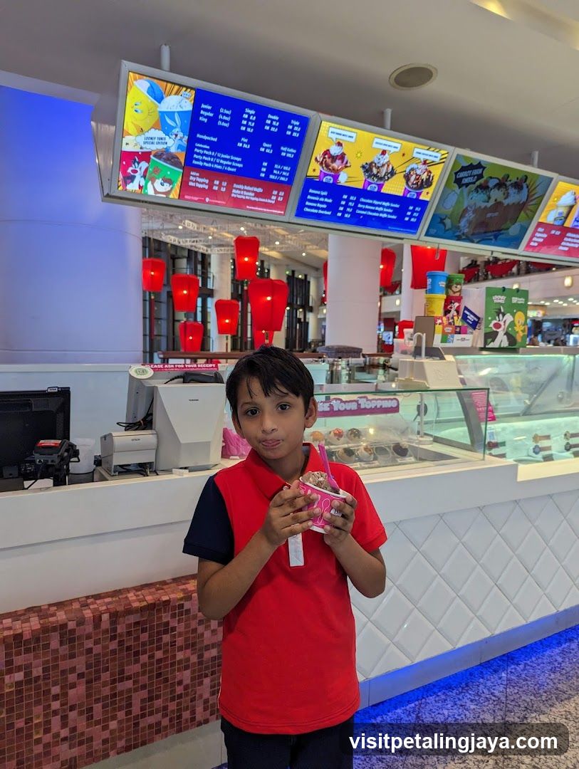 Boy holding ice cream in mall food court