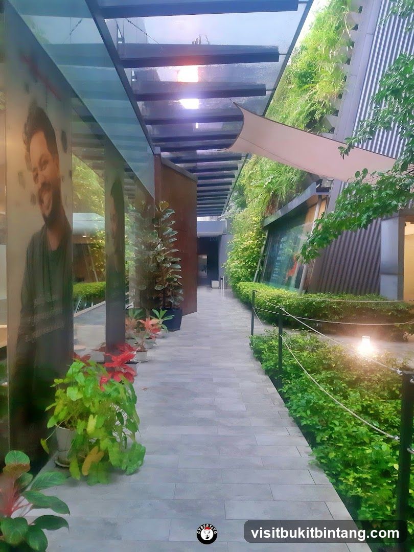 Outdoor walkway with greenery and artwork