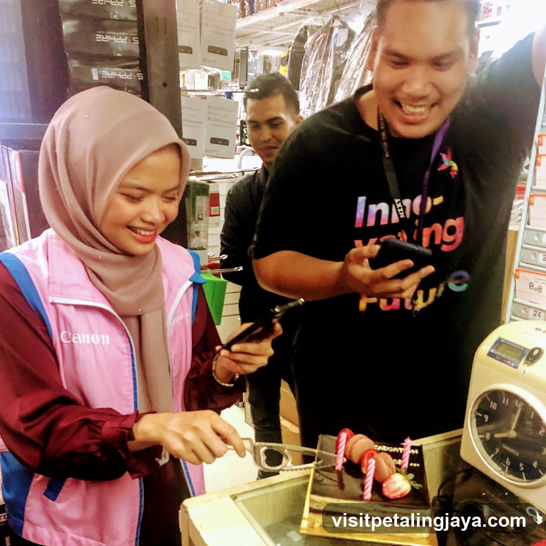 Staff cutting cake in store