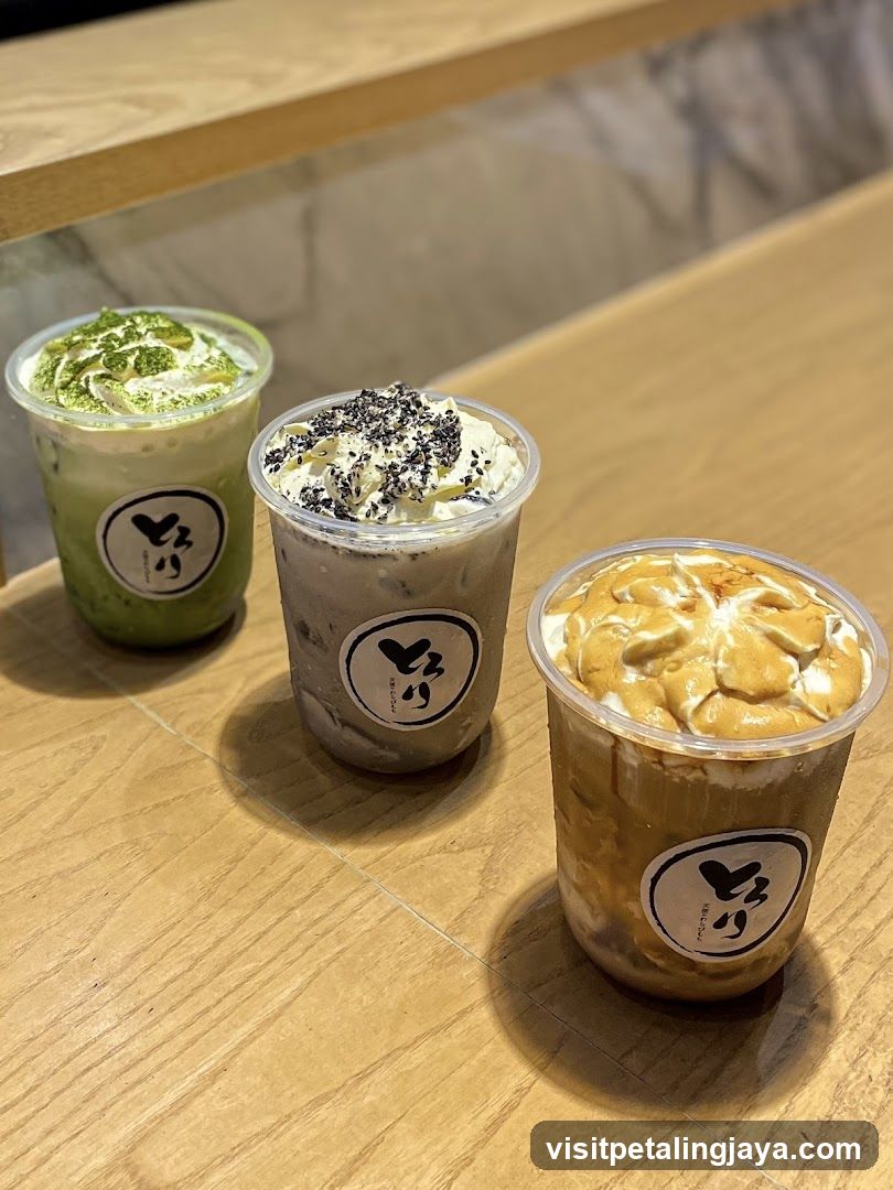 Three Matcha and Latte Drinks on a Wooden Table