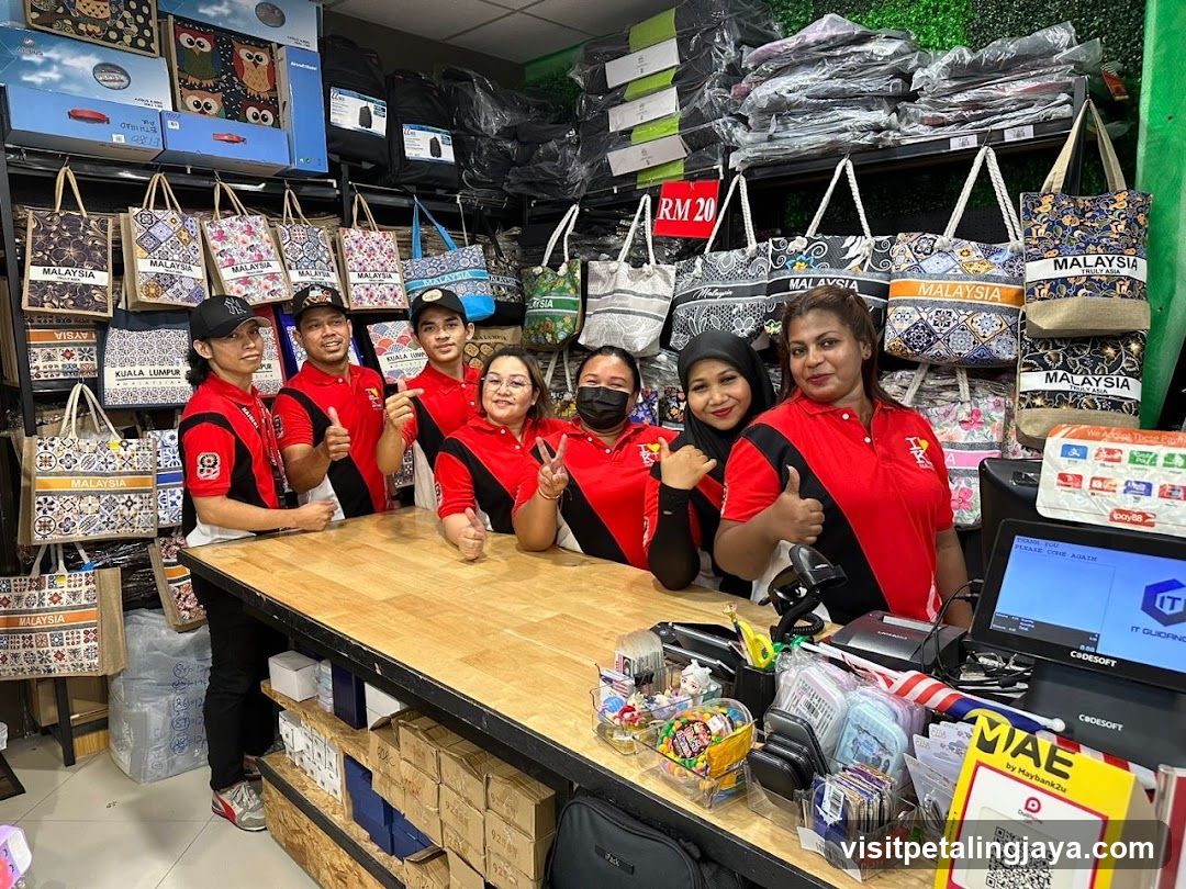 Staff in Red and Black Shirts at Counter